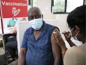 Raymond Auguste receives his second dose of COVID-19 vaccine by Niveny Sinniah on at a mobile unit in Rivieres-des-Prairies.