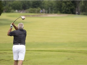 A golfer tees off during the golf day for the citizens of L'ile-Bizard – Sainte-Genevieve at the Saint-Raphael Golf Club on Tuesday.