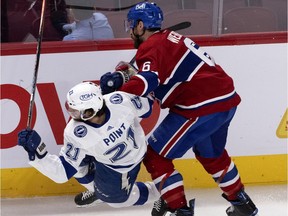 Montreal Canadiens defenceman Shea Weber delivers a thundering hit on Tampa Bay Lightning's Brayden Point during Game 4 of Stanley Cup final in Montreal on July 5, 2021.