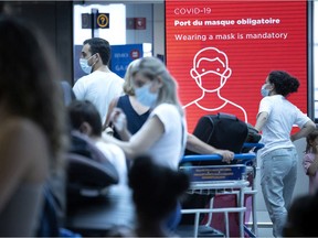 Travellers line up to check in at the Air Canada counter in Trudeau airport in Montreal on Monday, July 19, 2021.