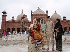COVID has changed so many things about how we celebrate and honour our traditions, Fariha Naqvi-Mohamed writes. Above: Friends gather at the Badshahi Mosque during Eid al-Adha, or the "Festival of Sacrifice," in Lahore, Pakistan.