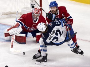 Canadiens defenceman Shea Weber sends Winnipeg Jets centre Mason Appleton to the ice as goaltender Carey Price reaches for the puck in Montreal on June 6, 2021.