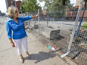 Longtime Milton-Parc resident Martine Michaud walks by a fenced-in area frequented by homeless people in the Montreal neighbourhood Monday July 26, 2021.