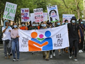 Mohamad Sayum, centre, the father of a recent shooting victim, leads a peace march through the streets of Little Burgundy on Tuesday July 27, 2021.