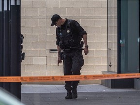 Police investigate the scene of a shooting near the Bell Centre on Friday July 30, 2021.