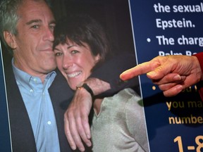 In this photo taken on July 2, 2020, a picture of Ghislaine Maxwell and Jeffrey Epstein is seen as acting U.S. Attorney for the Southern District of New York Audrey Strauss announces charges against Maxwell.