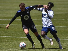 CF Montréal's Djordje Mihailovic, left, and Janio Bikel of Vancouver Whitecaps fight for the ball during a game on May 8, 2021, in Sandy, Utah.