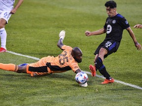 Joaquin Torres of CF Montréal gets the ball past goalkeeper Kenneth Vermeer of FC Cincinnati and scores in the first half during the MLS game at Saputo Stadium on Saturday, July 17, 2021, in Montreal.