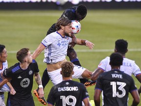 Tom Pettersson #3 of FC Cincinnati and Victor Wanyama #2 of CF Montreal jump for the ball in the first half during the MLS game at Saputo Stadium on July 17, 2021 in Montreal.