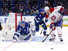 Canadiens' Corey Perry tries to deflect the puck past Lightning goalie Andrei Vasilevskiy as defenceman Erik Cernak looks on during Game 2 of the Stanley Cup final Wednesday night in Tampa.