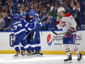 The Canadiens’ Tyler Toffoli skates past celebrating Tampa Bay Lightning players after Ondrej Palat scored with 0.3 seconds left on the clock at end of second period of Game 2 of Stanley Cup final.