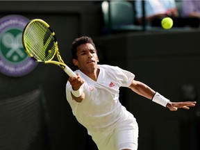 Félix Auger Aliassime of Canada plays a forehand during his men's Singles Quarter Final match against Matteo Berrettini of Italy on Day Nine of The Championships - Wimbledon 2021 at All England Lawn Tennis and Croquet Club on July 7, 2021 in London, England.