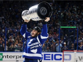 Mikhail Sergachev of the Tampa Bay Lightning celebrates with the Stanley Cup after the 1-0 victory against the Montreal Canadiens in Game Five to win the 2021 NHL Stanley Cup Final at Amalie Arena on July 07, 2021 in Tampa, Florida.