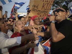 Singer Alexander Delgado from the group Gente de Zona sings to the crowd of protesters gathered near the Versailles restaurant in the Little Havana neighbourhood of Miami as they show support for the people in Cuba who have taken to the streets there to protest on July 14, 2021. Delgado is part of a group of musicians that created the song, 'Patria y Vida,' the unofficial anthem of those who demand a change in Cuba.