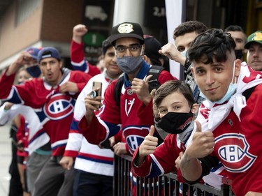 Fans line St-Antoine St. to catch a glimpse of the Canadiens arriving for Game 3 of the Stanley Cup Final against the Tampa Bay Lightning in Montreal on Friday, July, 2, 2021.