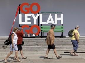 People pass by the tribute to tennis player Leylah Fernandez, located in the Old Port of Montreal on Friday, July 23, 2021.