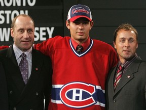 Former Canadiens general manager Bob Gainey (left) and current assistant GM Trevor Timmins (right) pose with goalie Carey Price after selecting him in the first round (fifth overall) of the 2005 NHL Draft.