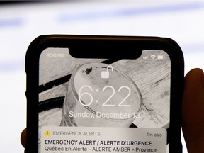 A mobile phone displays a province-wide Amber Alert in Montrea on Dec. 13, 2020.