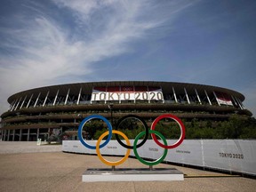 This picture shows the Olympic rings and Olympic Stadium in Tokyo on July 20, 2021, ahead of the Tokyo 2020 Olympic Games.