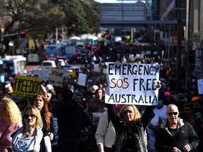 Protesters march through the city centre during an anti-lockdown rally as an outbreak of COVID-19 affects Sydney, Australia, on July 24, 2021.