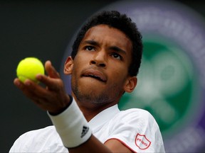 Montreal's Felix Auger-Aliassime serves against Australia's Nick Kyrgios during their men's singles third round match on the sixth day of the 2021 Wimbledon Championships at The All England Tennis Club in Wimbledon, southwest London, on Saturday, July 3, 2021.
