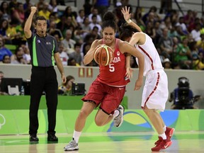Canada's guard Kia Nurse (L) runs past China's guard Zhao Zhifang during a Women's round Group A basketball match between China and Canada at the Youth Arena in Rio de Janeiro on August 6, 2016 during the Rio 2016 Olympic Games.