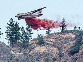 A Conair airtanker drops fire retardant on part of the Nk'Mip Creek wildfire near Osoyoos, British Columbia, Canada July 20, 2021.