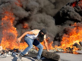 Palestinian demonstrators clash with Israeli soldiers as they demand that the army hands over the body of man who was shot dead by Israeli forces the previous night, in the village of Beita, in the occupied West Bank, on July 28, 2021.