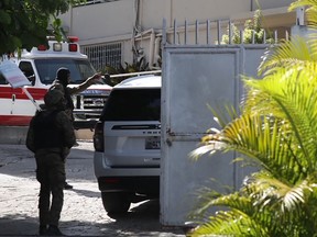 Vehicles and security members are seen near the hospital where Haitian first lady Martine Moïse was taken July 7, 2021, after Haitian president Jovenel Moïse was assassinated.