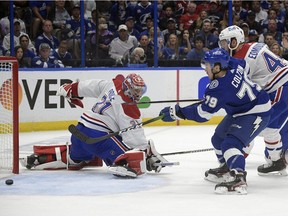 Lightning rookie Ross Colton scores the Game 5's only goal as Canadiens goaltender Carey Price and defenceman Joel Endmundson look on helplessly.  Tampa Bay won the game 1-0 to capture their second straight Stanley Cup.
