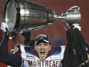 Martin Bédard of the Montreal Alouettes hoists the Grey Cup after his team won it in 2009.