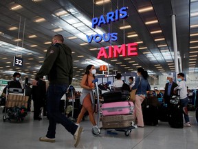 Passengers line up to check in inside the Terminal 3 at Orly Airport, near Paris, France, July 1, 2021. REUTERS/Sarah Meyssonnier