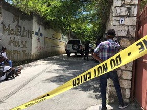 Journalists stand next to a yellow police cordon near the residence of Haiti's President Jovenel Moise after he was shot dead by unidentified attackers, in Port-au-Prince, Haiti July 7, 2021.