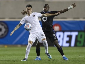 Inter Miami CF forward Julián Carranza, left, fights for the ball against CF Montréal defender Kamal Miller during an MLS soccer match on July 3 in Harrison, N.J.