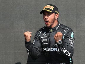 Mercedes' Lewis Hamilton celebrates on the podium after winning the race REUTERS/Peter Cziborra