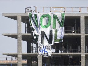 A Greenpeace banner reading "No GNL" is shown hanging from a building under construction on the site of the MIL campus of the University of Montreal in Montrea on Oct. 17, 2020. The GNL Quebec project seeks to export natural gas from Western Canada to European and Asian markets.