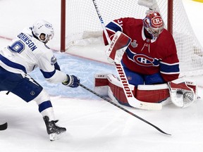 Montreal Canadiens goaltender Carey Price makes a save as Tampa Bay Lightning centre Tyler Johnson looks for a rebound in Montreal on July 5, 2021.