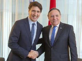 Prime Minister Justin Trudeau shakes hands with Quebec Premier François Legault before their meeting in Montreal, Friday, Dec. 13, 2019. Tom Mulcair says the Trudeau government did not mount any real opposition to Bill 21, which discriminates against religious minorities, and has not shown any inclination to get in Legault's way over Quebec's new language legislation, Bill 96, either.