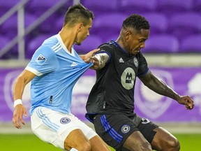CF Montréal forward Romell Quioto grabs the shirt of New York City midfielder Alfredo Morales during the first half at Orlando's Exploria Stadium on Wednesday July 7, 2021.