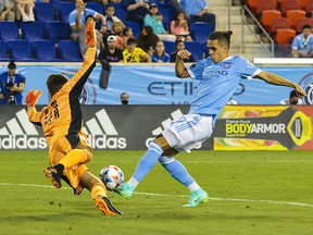 New York City forward Jesus Medina looks to shoot as CF Montréal goalkeeper James Pantemis defends during the second half at Red Bull Arena Wednesday night.