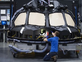An employee inspects a Boeing Co. 787 cockpit shell and main instrument panel (MIP) at a CAE Inc. facility in Montreal.