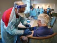 A healthcare worker administers a Pfizer-COVID-19 vaccine at the John Knox Village Continuing Care Retirement Community on Jan. 6 in Pompano Beach, Florida