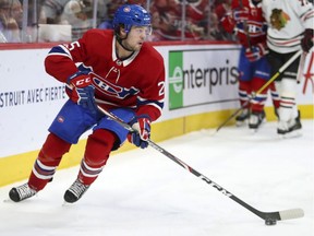 Montreal Canadiens' Ryan Poehling handles the puck behind the net during first period against the Chicago Blackhawks in Montreal on Jan. 15, 2020.