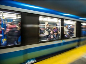 Passengers ride in a metro car.