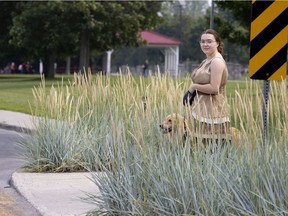 Maxime and her dog Cap, struggle to safely cross LaSalle Blvd. after the city planted almost shoulder height plants on both sides of the entrance to the cross walk on July 26, 2021.