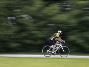 A cyclist gets in ride along a bike path in Verdun in Montreal, on July 26, 2021.