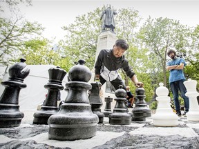 Eliot Finley and Jeffrey Wayne Kasuduak play chess in Cabot Square in Montreal on July 29, 2021.