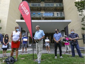 Marvin Rotrand, city councillor in the Côte-des-Neiges–Notre-Dame-de-Grâce borough, centre, holds a press conference outside an apartment building on Bourret St. in Montreal on Saturday, August 7, 2021, to bring attention to the evictions happening there at the hands of property manager COGIR.