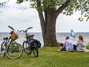 Jason Moscovitch and his wife, Keely McGlynn enjoy a quiet moment on the Pointe-Claire shoreline watching the sailboarders going by on August 12, 2021, the day before McGlynn celebrates her 40th birthday.