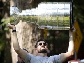 Tampa Bay Lightning player Alex Killorn carries the Stanley Cup. Killorn, 31, who plays left wing on the Tampa Bay Lightning, was given the keys to the city of Beaconsfield, signed the Livre d'or and his parents received a painting, as hundreds cheered at Beaconsfield's Centennial Park on Friday.